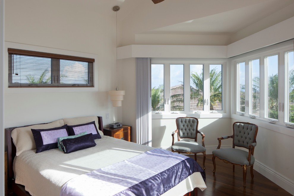 Design ideas for a tropical bedroom in Hawaii with white walls and dark hardwood floors.