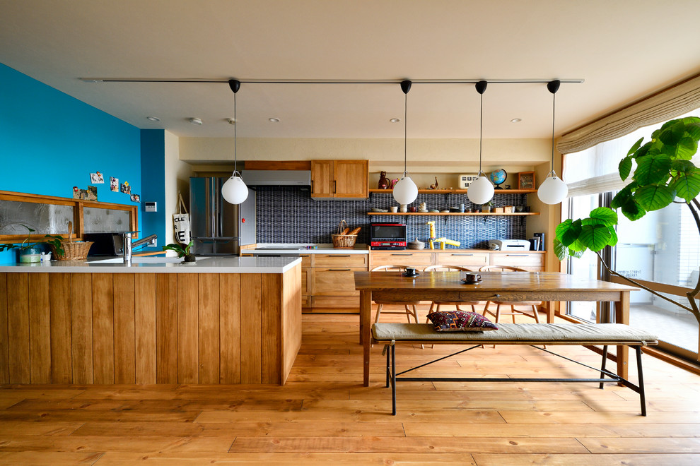 Photo of an asian kitchen/dining combo in Other with beige walls, medium hardwood floors and beige floor.