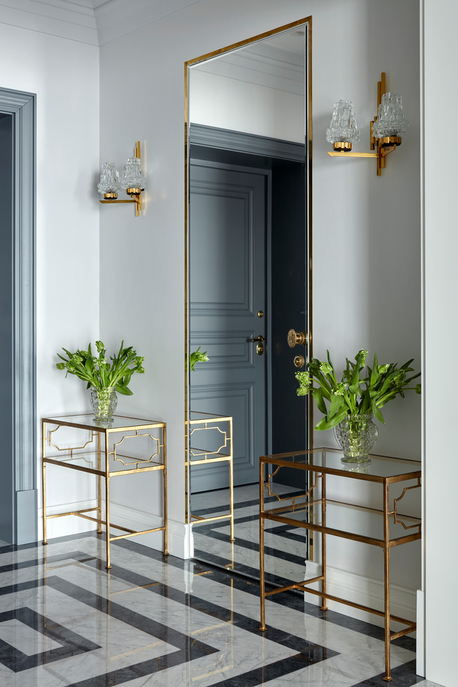 Design ideas for a transitional foyer in Moscow with white walls, marble floors, a single front door and a gray front door.