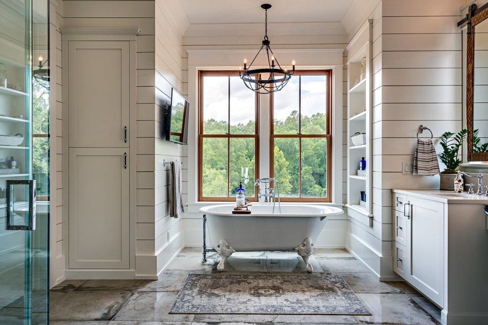 Photo of a large country master bathroom in Nashville with shaker cabinets, grey cabinets, a claw-foot tub, white walls, grey floor, white benchtops, a corner shower, concrete floors, an undermount sink and a hinged shower door.