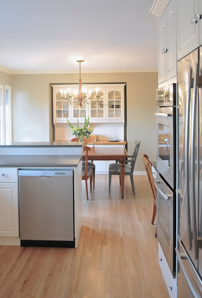 Example of a transitional kitchen design in Calgary