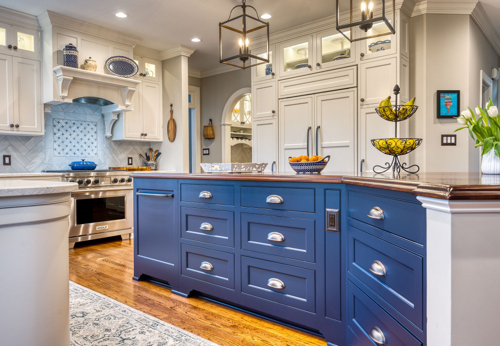 This is an example of a medium sized kitchen in DC Metro with a belfast sink, shaker cabinets, white cabinets and engineered stone countertops.