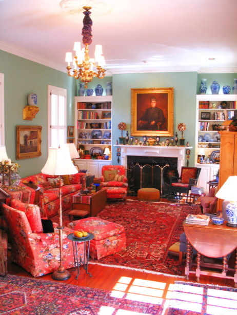 This is an example of a large traditional enclosed family room in Atlanta with a library, green walls, medium hardwood floors, a standard fireplace and a wood fireplace surround.