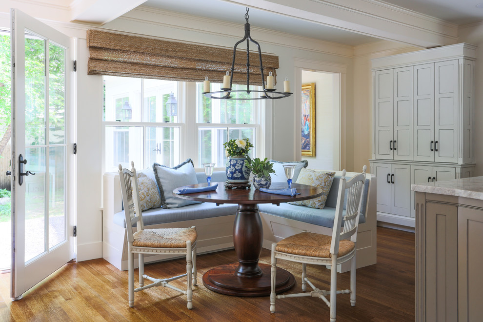 Design ideas for a traditional dining room in Boston with beige walls and medium hardwood floors.