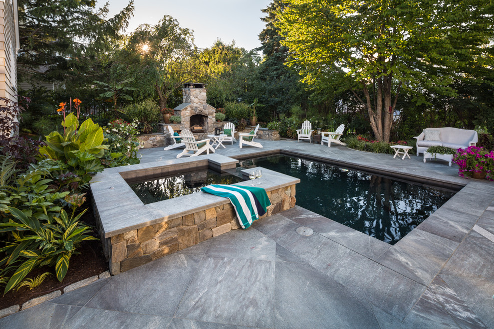 Inspiration for a mid-sized traditional side yard rectangular lap pool in Portland Maine with a hot tub and natural stone pavers.