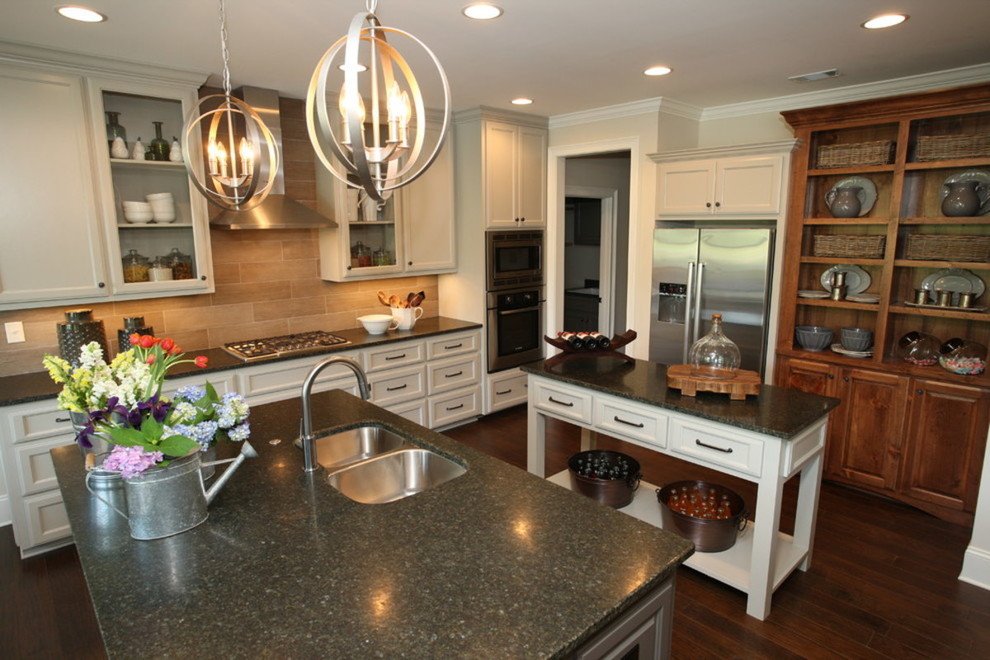 Mid-sized transitional galley dark wood floor enclosed kitchen photo in Atlanta with an undermount sink, shaker cabinets, medium tone wood cabinets, granite countertops, orange backsplash, marble backsplash, stainless steel appliances and an island