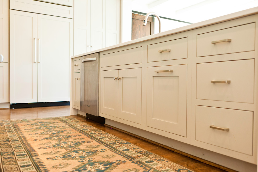 Inspiration for a transitional single-wall eat-in kitchen remodel in Charlotte with white cabinets, green backsplash, stainless steel appliances and an island