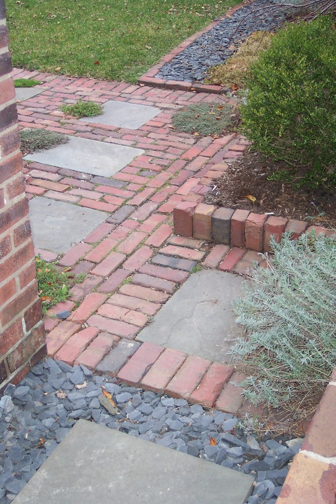 Photo of a mid-sized traditional backyard patio in Chicago with brick pavers and no cover.