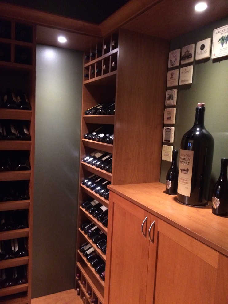 Photo of a small midcentury wine cellar in Salt Lake City with light hardwood floors, storage racks and beige floor.