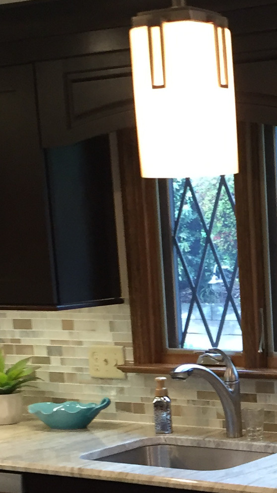 Inspiration for a transitional ceramic tile kitchen remodel with a single-bowl sink, dark wood cabinets, multicolored backsplash, mosaic tile backsplash, stainless steel appliances and an island
