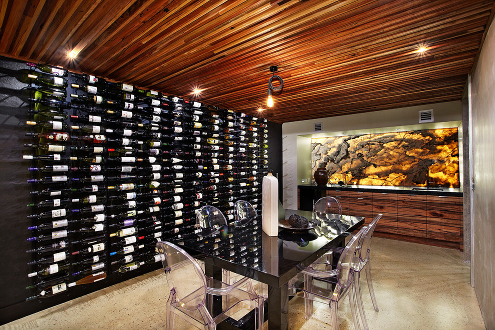 This is an example of a contemporary wine cellar in Melbourne with concrete floors and beige floor.