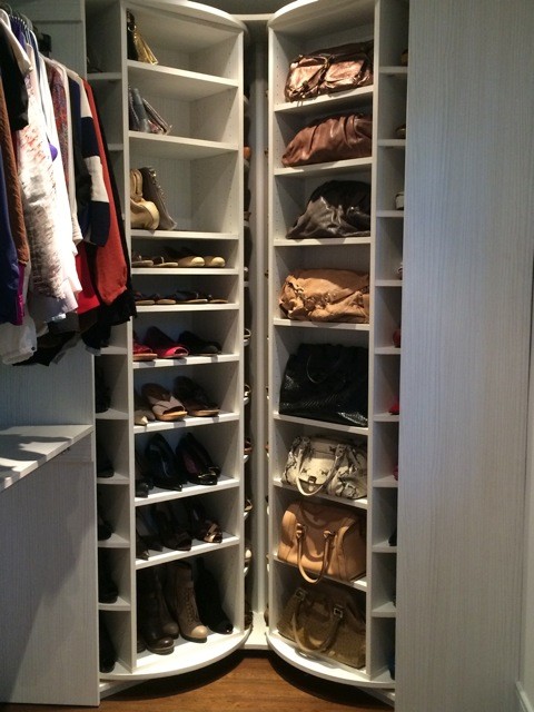Photo of a large modern women's walk-in wardrobe in Miami with white cabinets.