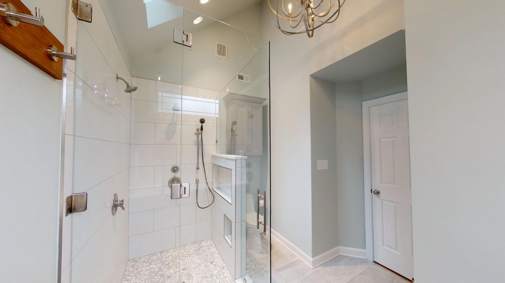 Inspiration for a small modern master bathroom in Raleigh with shaker cabinets, white cabinets, a one-piece toilet, white tile, pebble tile, green walls, porcelain floors, an undermount sink, engineered quartz benchtops, grey floor, a hinged shower door, white benchtops, a niche, a double vanity and a built-in vanity.