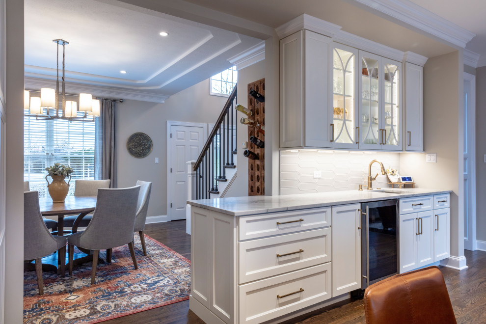 Kitchen - transitional medium tone wood floor kitchen idea with shaker cabinets, quartzite countertops, stainless steel appliances and an island