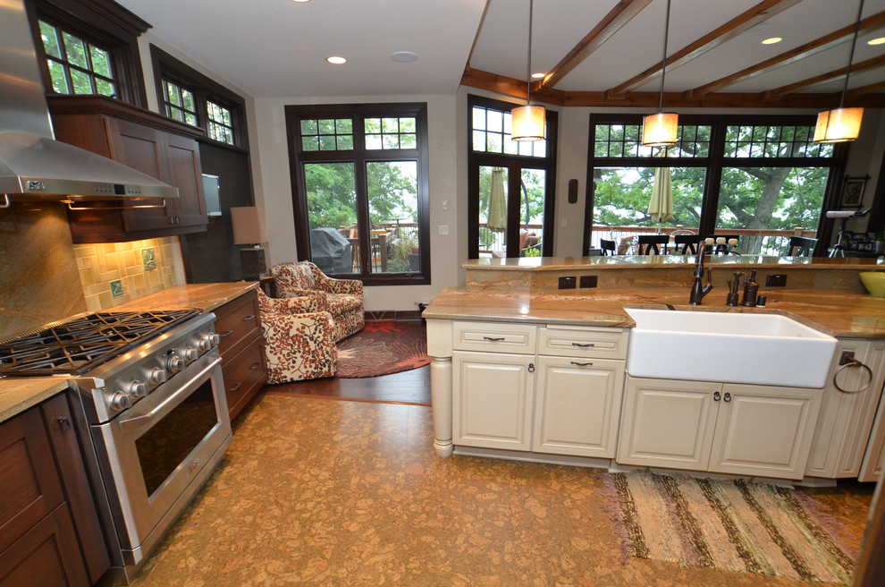 Huge transitional cork floor eat-in kitchen photo in Milwaukee with a farmhouse sink, raised-panel cabinets, medium tone wood cabinets, granite countertops, stone tile backsplash, stainless steel appliances and an island