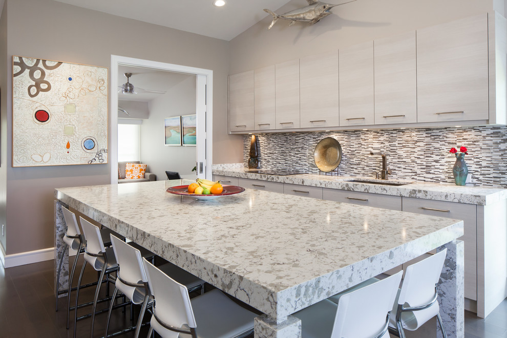 This is an example of a mid-sized contemporary galley eat-in kitchen in Miami with an undermount sink, granite benchtops, stainless steel appliances, with island, flat-panel cabinets, distressed cabinets, multi-coloured splashback, matchstick tile splashback and dark hardwood floors.