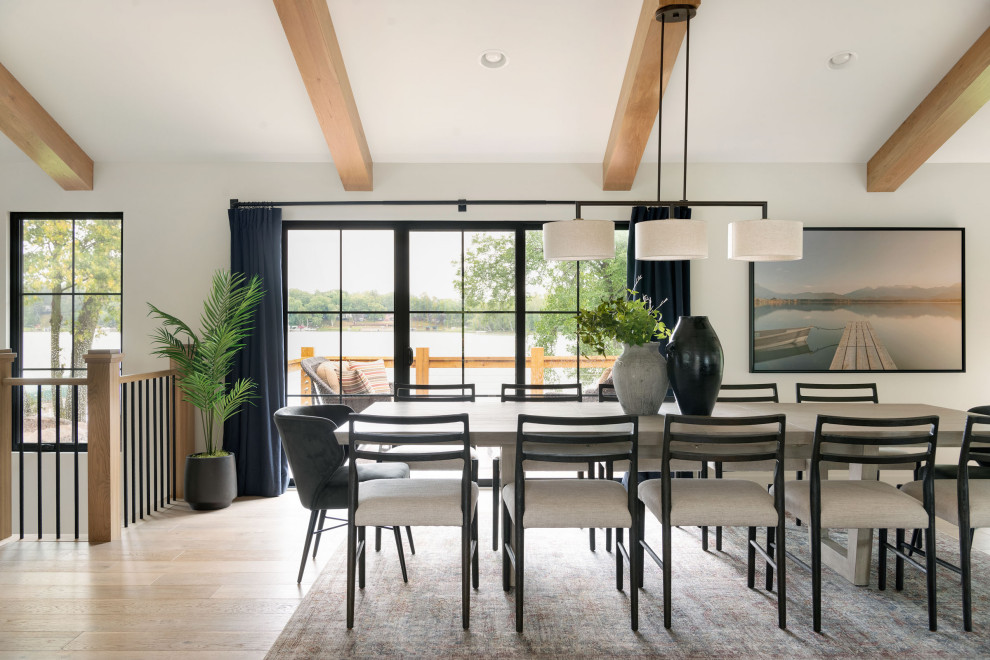 Design ideas for a beach style open plan dining in Minneapolis with white walls, light hardwood floors, no fireplace, exposed beam and vaulted.