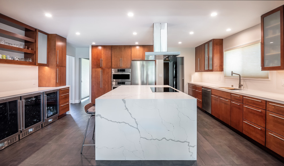 Design ideas for a contemporary u-shaped kitchen in Los Angeles with an undermount sink, flat-panel cabinets, medium wood cabinets, marble benchtops, white splashback, stainless steel appliances, medium hardwood floors, with island, brown floor and white benchtop.