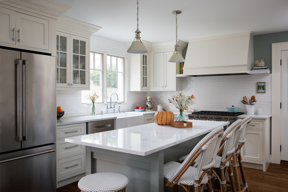 Mid-sized transitional dark wood floor and brown floor kitchen photo with white backsplash, white appliances, an island and white countertops