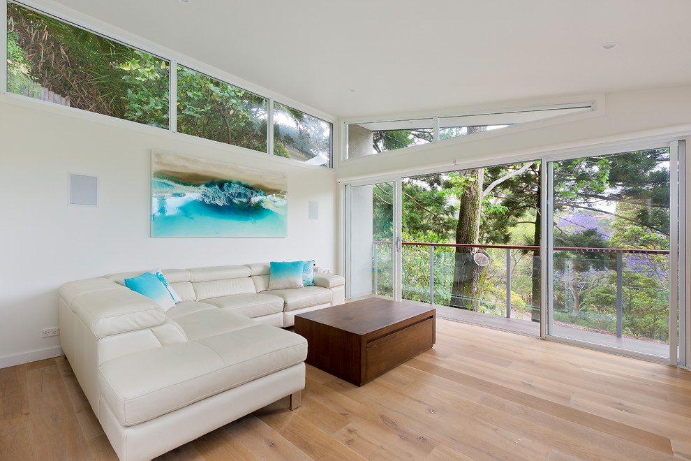 Photo of a mid-sized contemporary formal open concept living room in Sydney with white walls and brown floor.