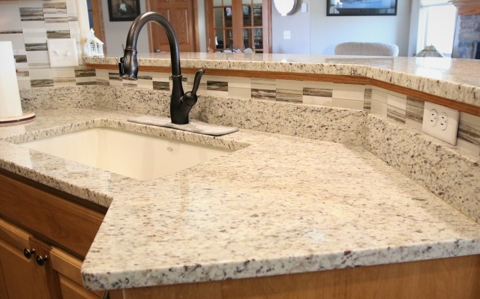 Eat-in kitchen - small eat-in kitchen idea with granite countertops, multicolored backsplash, mosaic tile backsplash and multicolored countertops