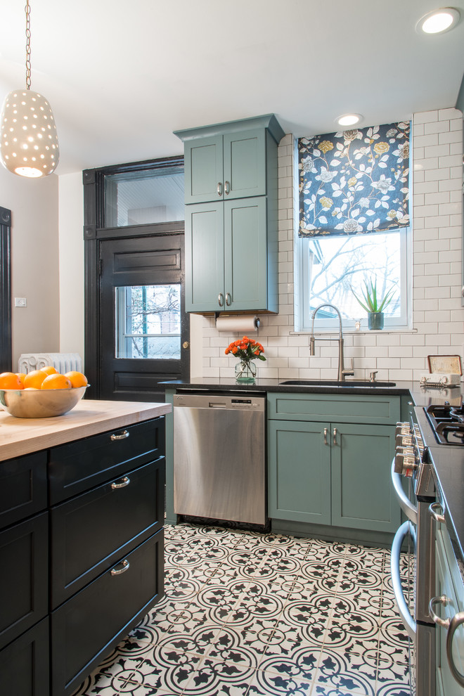 Small country l-shaped kitchen in St Louis with shaker cabinets, blue cabinets, quartz benchtops, white splashback, subway tile splashback, stainless steel appliances, porcelain floors, with island and an undermount sink.