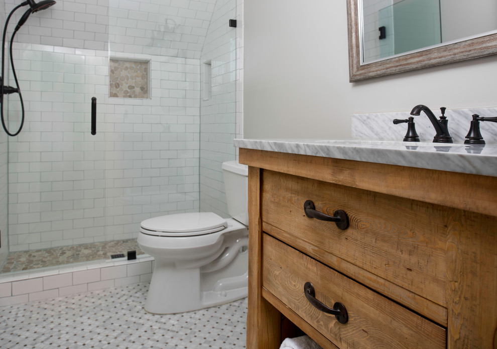 This is an example of a small country kids bathroom in Atlanta with flat-panel cabinets, light wood cabinets, an alcove shower, a two-piece toilet, white tile, ceramic tile, grey walls, marble floors, an undermount sink, quartzite benchtops, multi-coloured floor and a hinged shower door.
