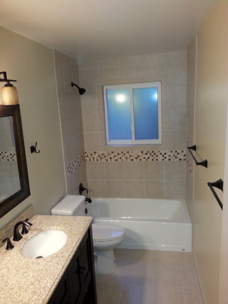 Mid-sized transitional 3/4 bathroom in Other with furniture-like cabinets, dark wood cabinets, an alcove tub, a shower/bathtub combo, a two-piece toilet, beige walls, porcelain floors, an undermount sink, solid surface benchtops, beige floor, a shower curtain and multi-coloured benchtops.