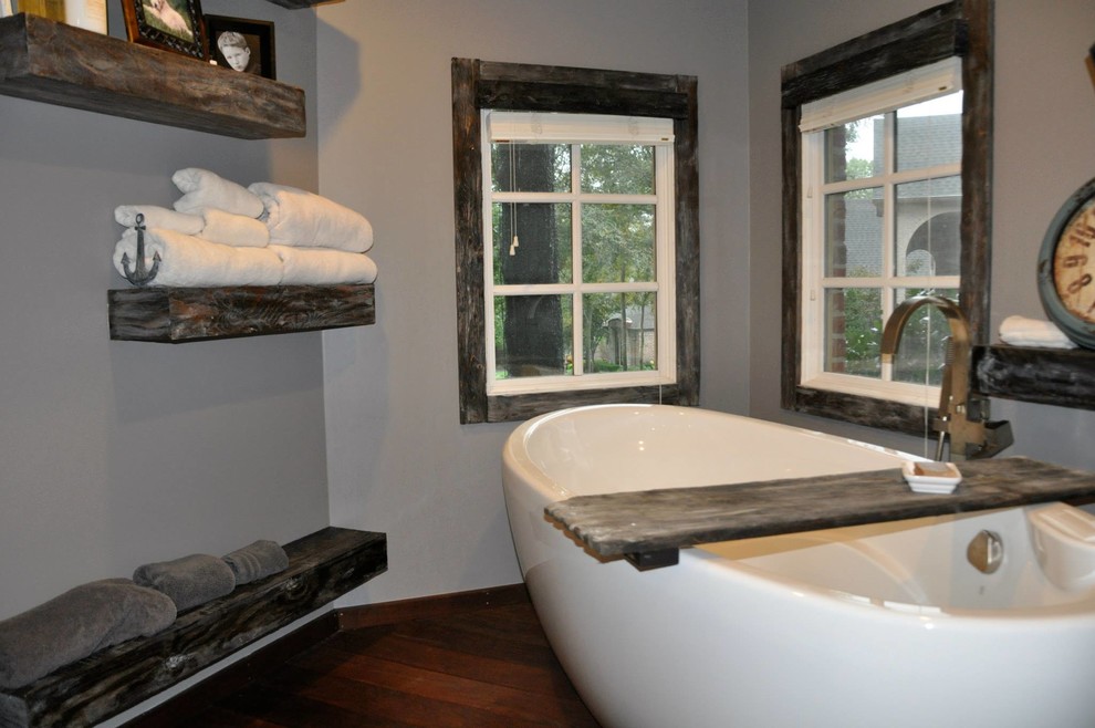 This is an example of a large arts and crafts master bathroom in Other with raised-panel cabinets, grey cabinets, a freestanding tub, a corner shower, grey walls, laminate floors, a vessel sink and soapstone benchtops.
