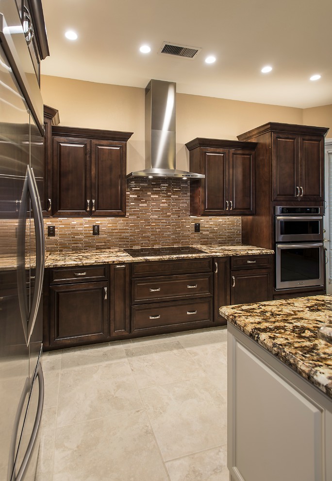 Inspiration for a mid-sized transitional l-shaped ceramic tile open concept kitchen remodel in Phoenix with an undermount sink, raised-panel cabinets, dark wood cabinets, granite countertops, brown backsplash, glass tile backsplash, stainless steel appliances and an island
