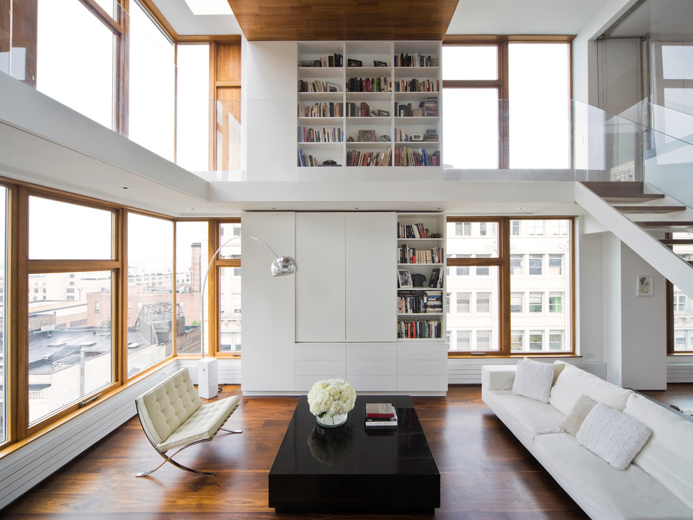 Photo of a modern living room in New York with a library.