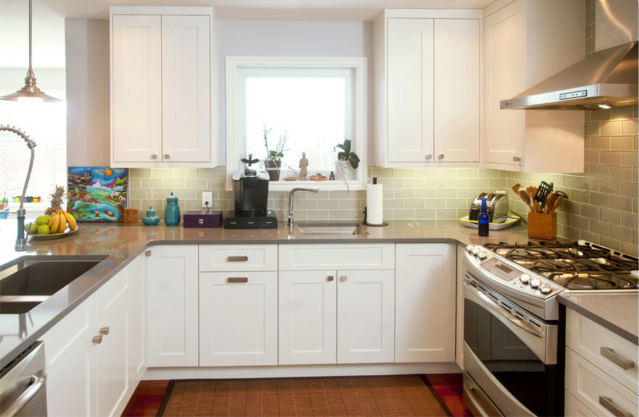 Example of a small transitional u-shaped dark wood floor eat-in kitchen design with an undermount sink, shaker cabinets, white cabinets, quartzite countertops, gray backsplash, glass tile backsplash, stainless steel appliances and a peninsula