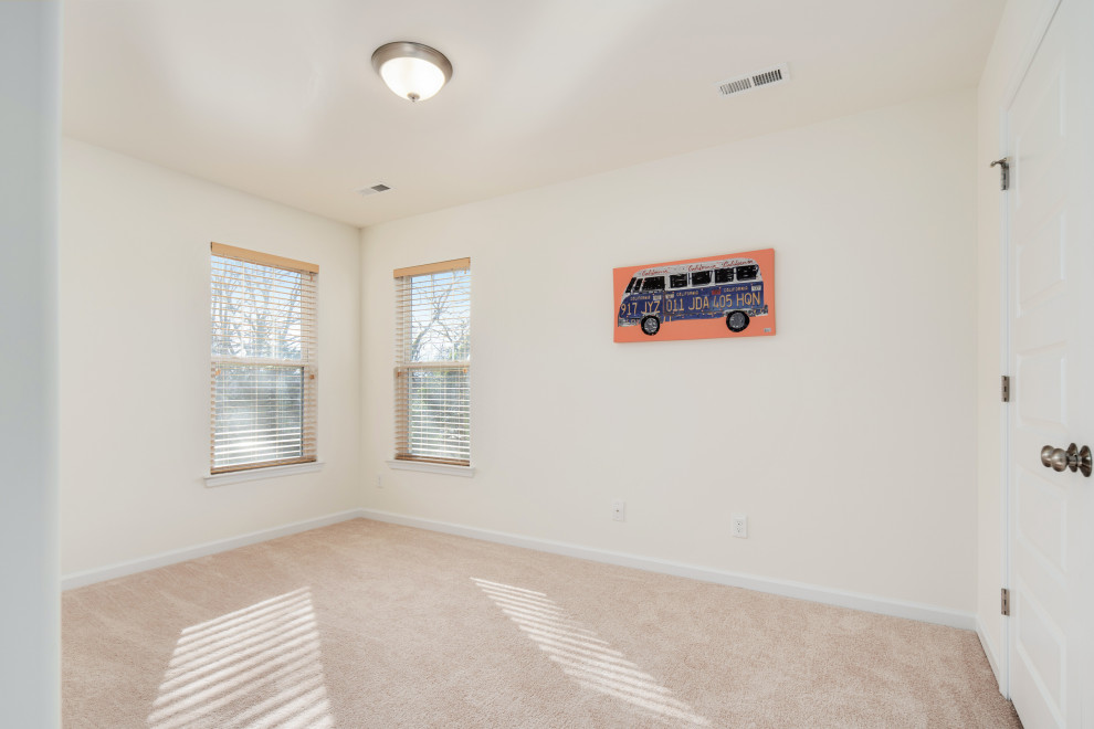 Mid-sized traditional guest bedroom in DC Metro with beige walls, carpet, no fireplace and beige floor.