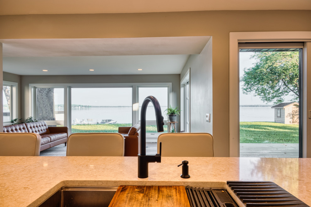 Open concept kitchen - mid-sized transitional galley vinyl floor and brown floor open concept kitchen idea with an undermount sink, flat-panel cabinets, light wood cabinets, quartz countertops, an island and white countertops