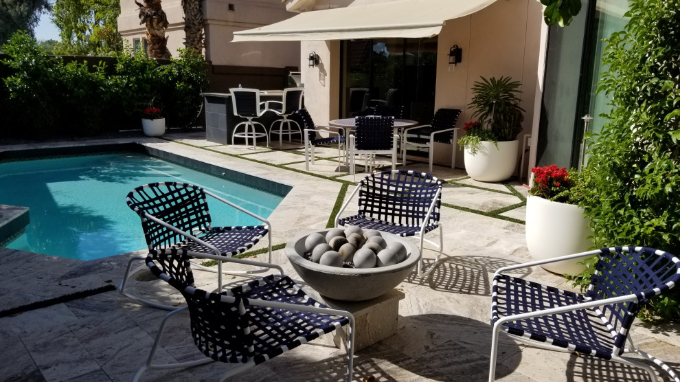 Example of a mid-sized transitional backyard tile and custom-shaped lap pool design in Phoenix