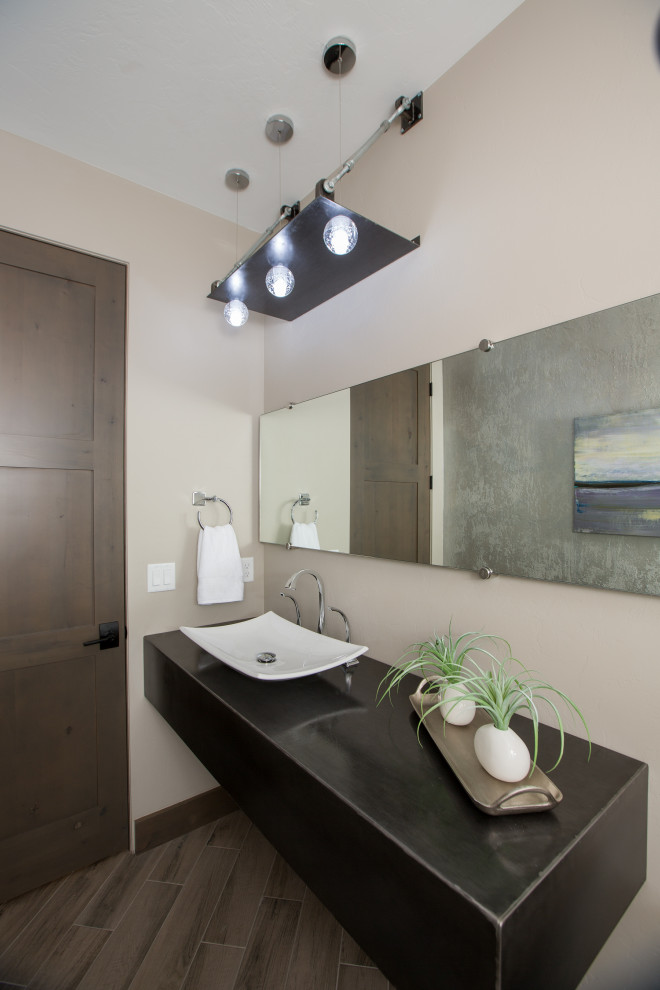 This is an example of a mid-sized contemporary master bathroom in Other with flat-panel cabinets, black cabinets, stainless steel benchtops and black benchtops.