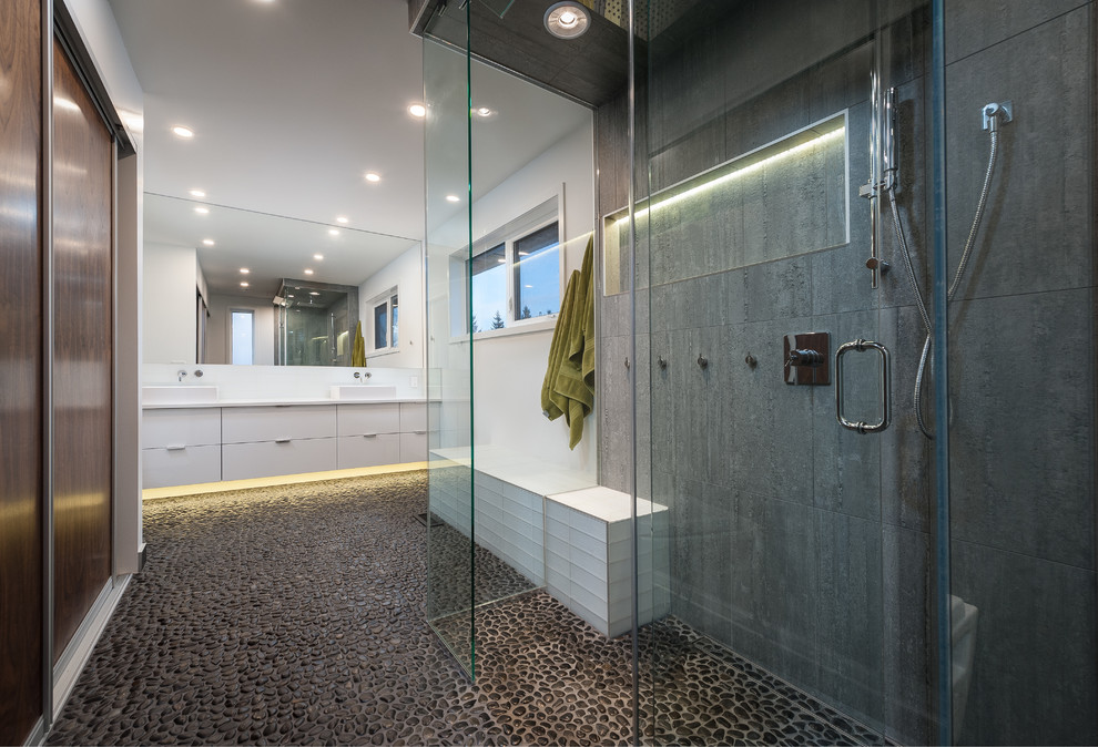 Contemporary bathroom in Calgary with a vessel sink, a curbless shower, pebble tile and pebble tile floors.