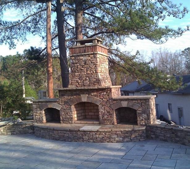 Mid-sized arts and crafts backyard patio in Atlanta with with fireplace, concrete pavers and no cover.