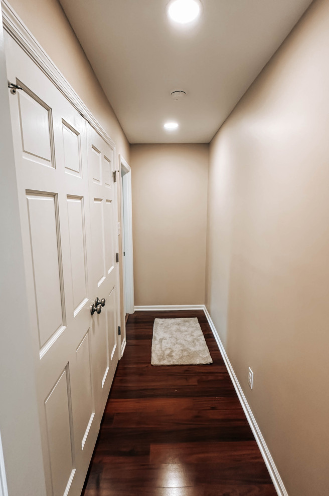 Hallway - small transitional dark wood floor and brown floor hallway idea with beige walls