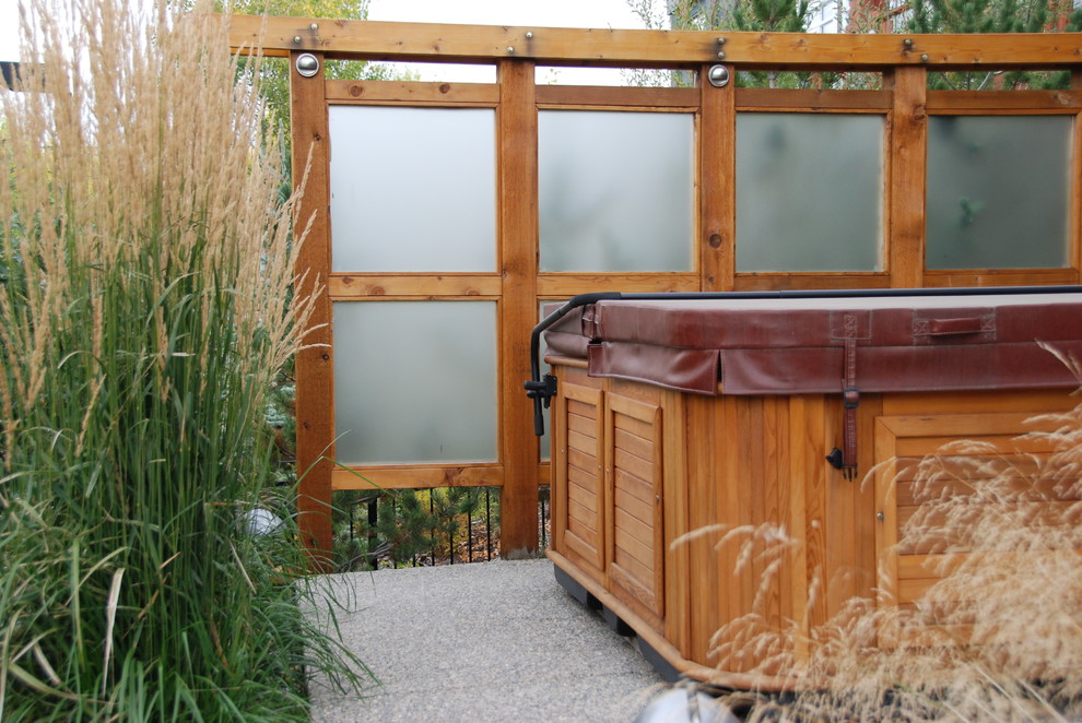 Example of a small transitional backyard rectangular aboveground hot tub design in Calgary