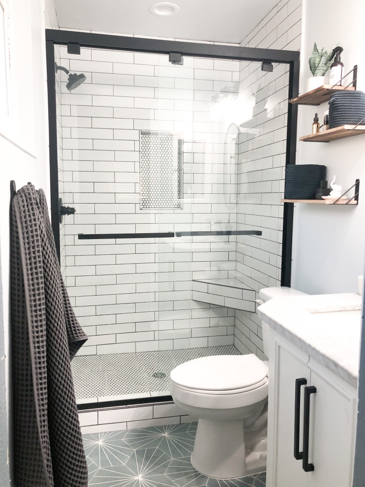 Design ideas for a small modern 3/4 bathroom in Orange County with white cabinets, a two-piece toilet, black and white tile, ceramic tile, blue walls, cement tiles, blue floor, a sliding shower screen, white benchtops, a shower seat, a single vanity and a freestanding vanity.