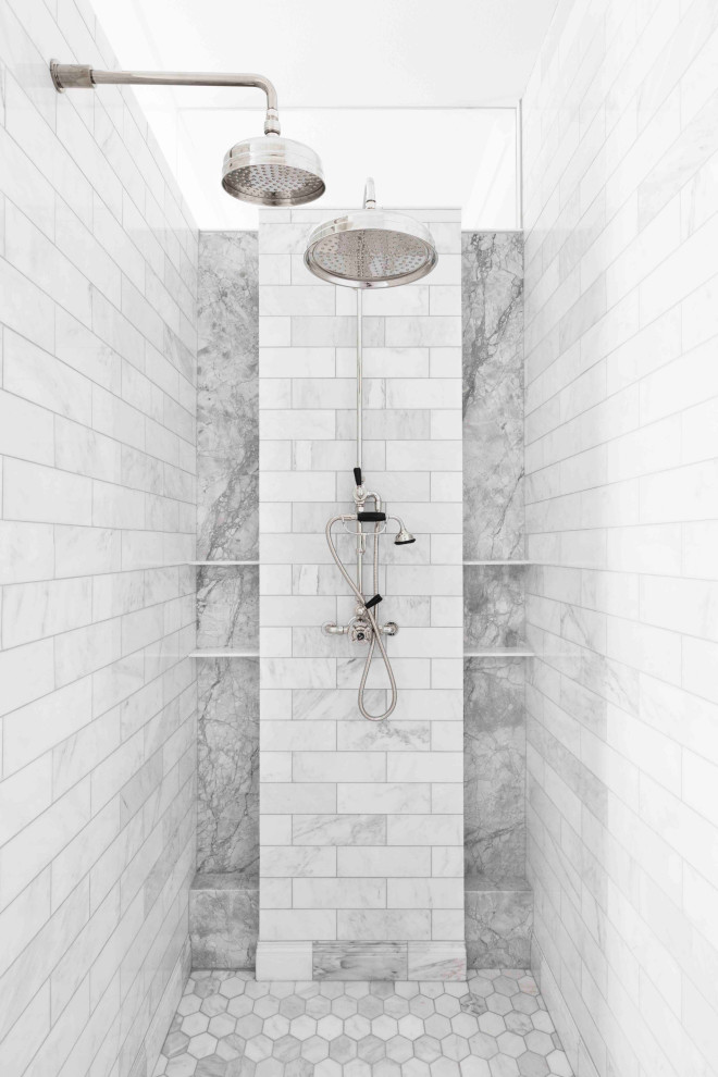 Freestanding bathtub - large transitional master white tile and marble tile marble floor and gray floor freestanding bathtub idea in Milwaukee with furniture-like cabinets, white cabinets, white walls, an undermount sink, marble countertops and gray countertops