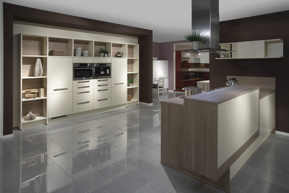 This is an example of a contemporary kitchen in Other with flat-panel cabinets and white cabinets.