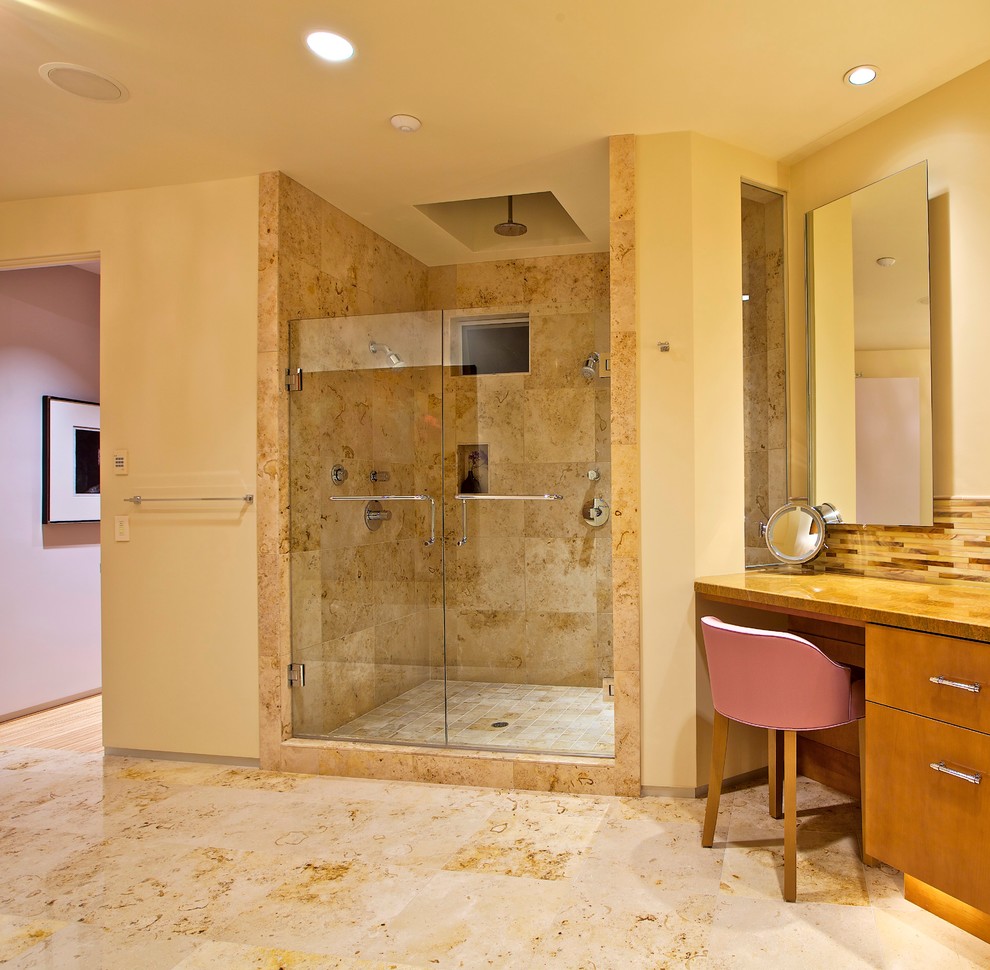 Inspiration for a large modern master bathroom in San Diego with flat-panel cabinets, granite benchtops, multi-coloured tile, beige walls, limestone floors, medium wood cabinets, an alcove shower, glass tile, an undermount sink, beige floor and a hinged shower door.
