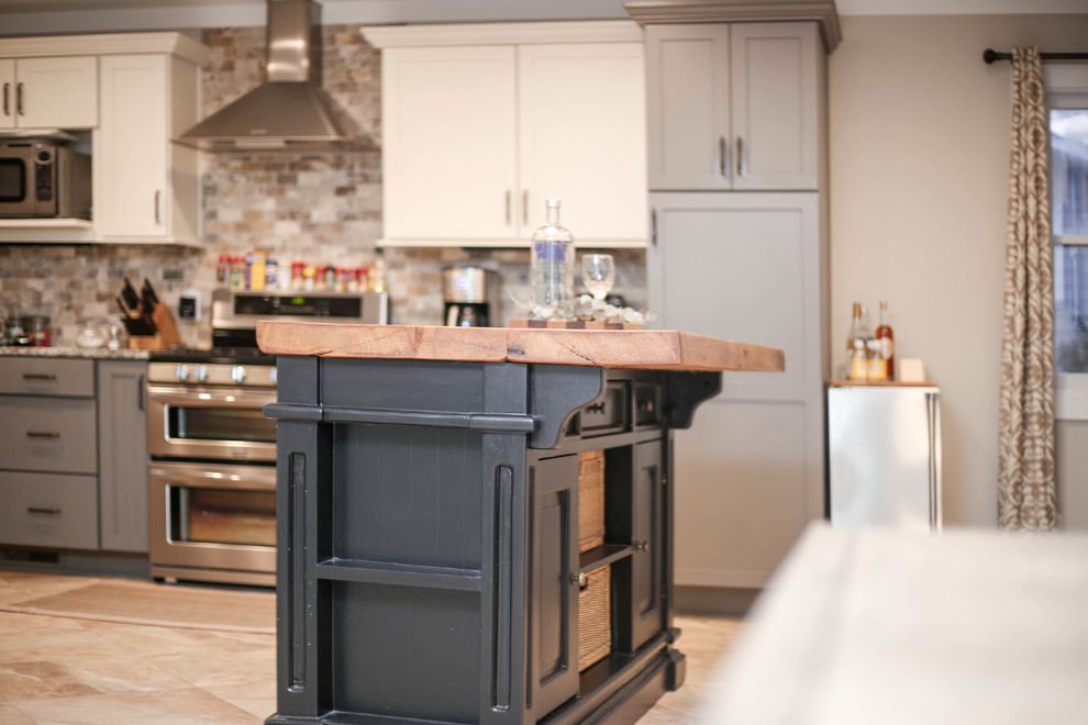 Inspiration for a medium sized country single-wall kitchen/diner in Other with shaker cabinets, grey cabinets, wood worktops, grey splashback, brick splashback, stainless steel appliances, ceramic flooring, an island, grey floors and brown worktops.