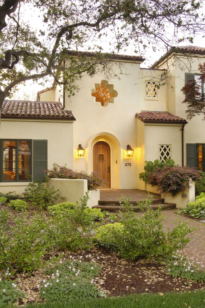 Inspiration for a mediterranean two-storey stucco exterior in San Francisco with a tile roof.