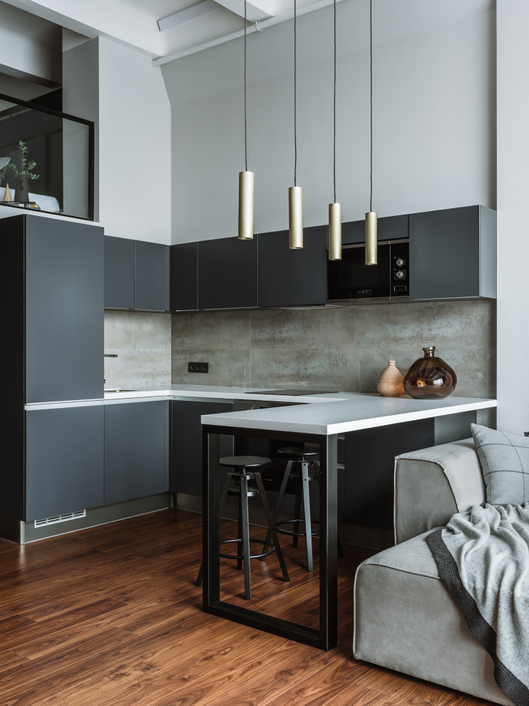 Inspiration for a contemporary u-shaped kitchen in Moscow with flat-panel cabinets, grey cabinets, grey splashback, stainless steel appliances, dark hardwood floors, a peninsula, brown floor and white benchtop.