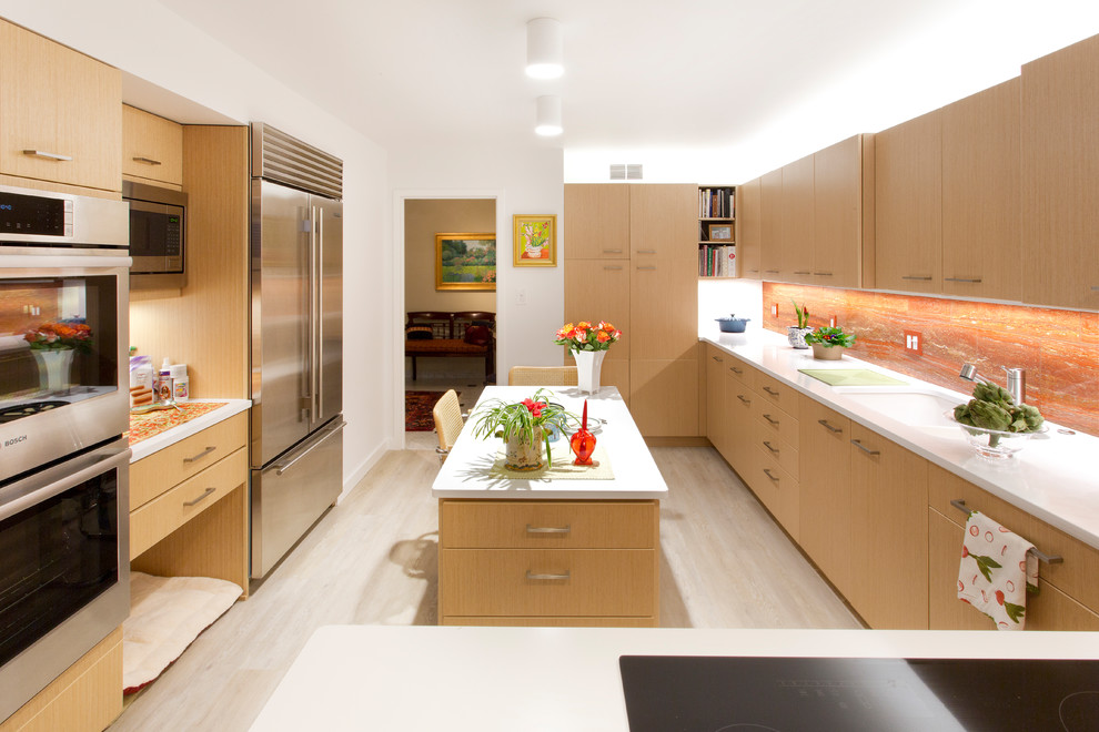 Mid-sized modern kitchen in Cleveland with an undermount sink, flat-panel cabinets, light wood cabinets, quartz benchtops, orange splashback, stainless steel appliances, laminate floors, with island and grey floor.