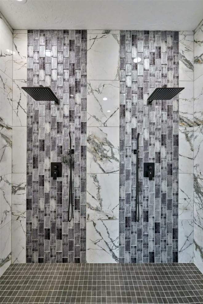 Inspiration for a large black and white tile and marble tile marble floor wet room remodel with brown walls and a hinged shower door