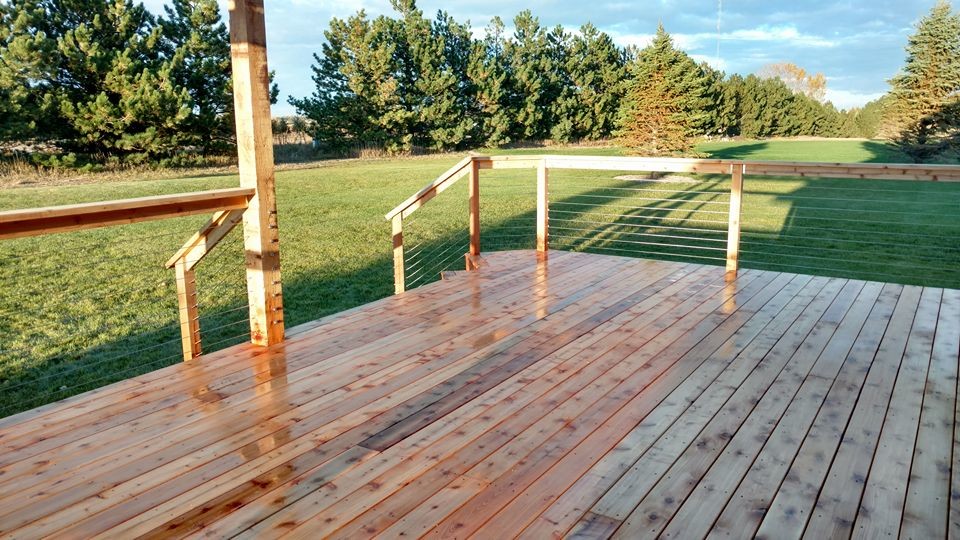 Large mountain style deck photo with a pergola